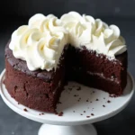 Homemade dog birthday cake with carob and yogurt frosting on white cake stand